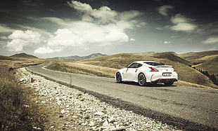 white coupe on empty road