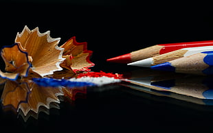 white pencil in middle of blue and red colored pencils