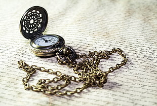 silver pocket watch on surface
