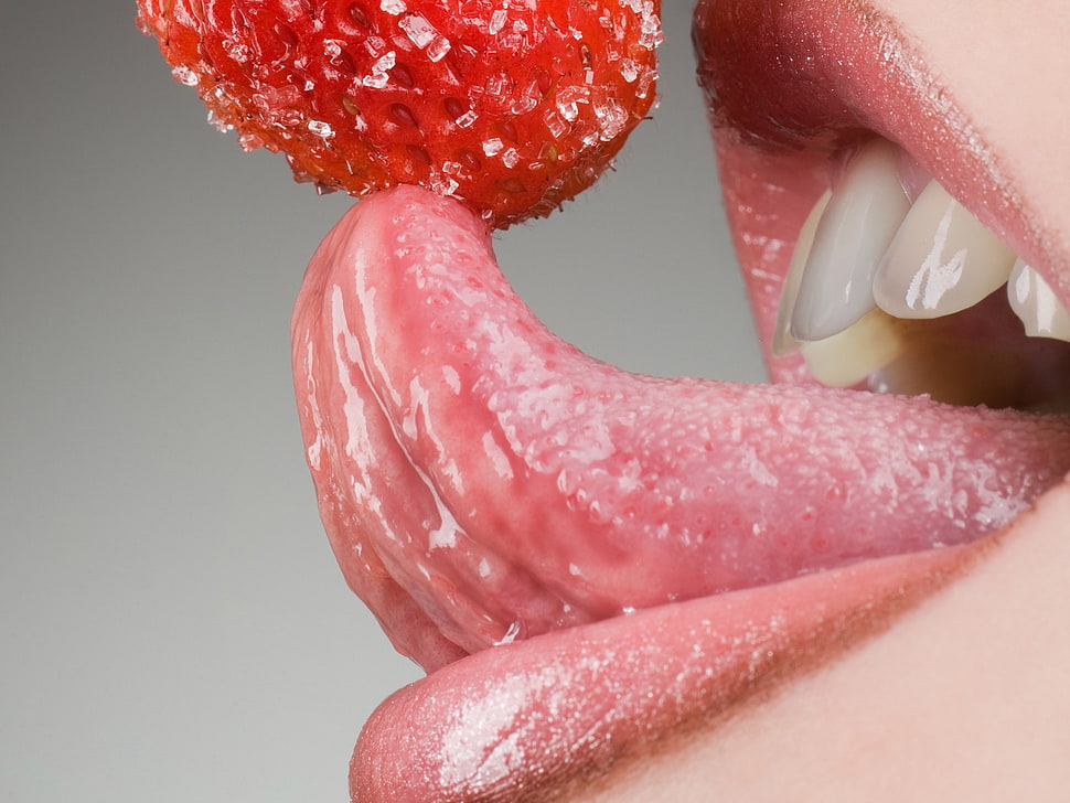 person licking strawberry HD wallpaper