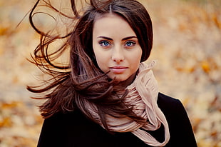 selective focus photography of woman wearing brown scarf
