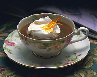 cream on coffee on white ceramic teacup