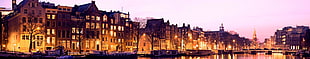 panoramic photo of brown buildings, canal, street, city, lights