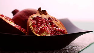 round red fruit on black ceramic plate HD wallpaper
