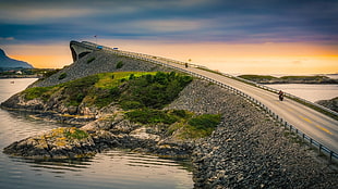 landscape photography of island concrete bridge, motorcycle, Atlantic Ocean Road, Norway HD wallpaper