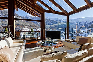 round clear glass-top table, indoors, mountains, house, telescope