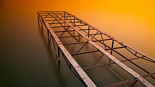 gray metal folding bed frame, water, pier, wood
