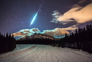 meteor about to land near mountain digital wallpaper