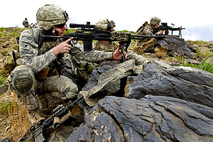 man in army suit holding black rifle with scope during daytime HD wallpaper