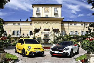 yellow and white concept cars in front of yellow and white concrete house during daytime