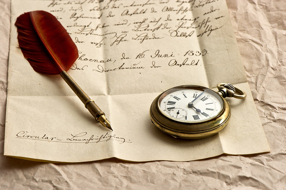 brass-colored pocket watch near ink pen HD wallpaper