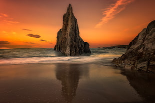 rock formation on seashore during golden hour