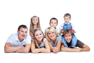 three children sitting on back of four people on floor with white background