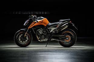 orange and black naked sports bike