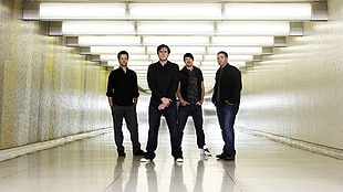 four men in black shirt