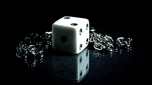 silver-colored chain necklace with dice pendant
