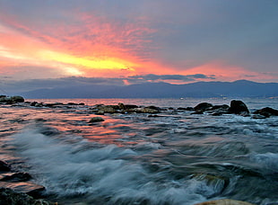 photo of tidal wave in body of water sea during sunset, reggio
