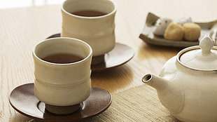 two white ceramic teacups on brown ceramic saucers HD wallpaper
