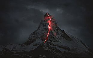 mountain with red lights under cloudy sky HD wallpaper