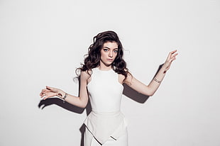 Lorde with white crew-neck sleeveless dress