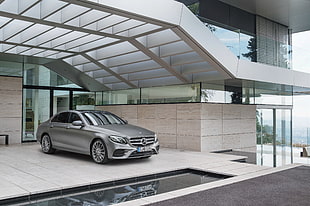 gray Mercedes-Benz sedan parked near clear glass wall