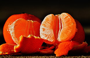 two peeled orange fruits