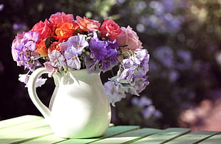 tilt lens shot of bouquet of flowers in white ceramic vase