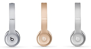 two silver and gold Beats wireless headphones