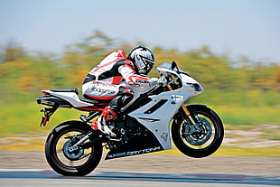 motocross rider on white and black Daytona sports bike