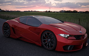 red sports coupe during sunset