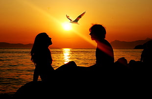 silhouette of a man and woman during sunset photo