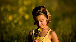 girl wearing tank top holding sunflower HD wallpaper