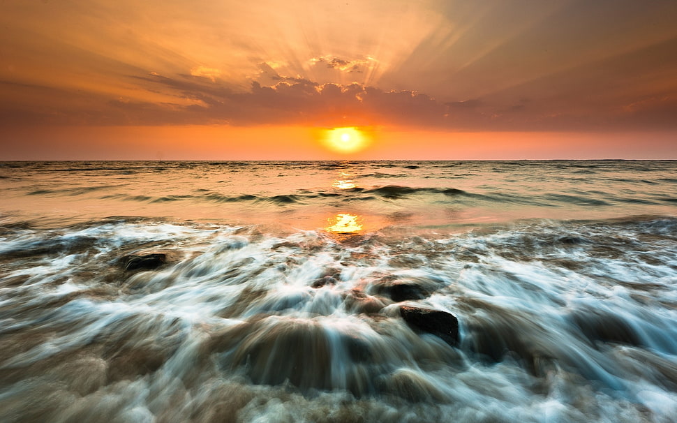 timelapse photography of sea waves during golden hour HD wallpaper