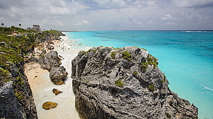gray rock formation near seashore high-angle photography