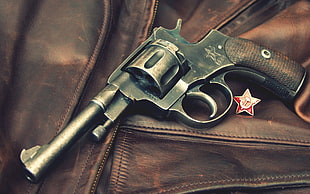 black and brown revolver pistol on brown leather zip-up jacket HD wallpaper