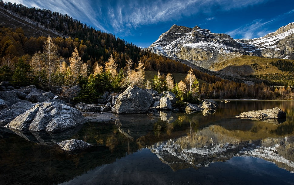 green mountain near river during daytime HD wallpaper