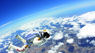 person in white Red Bull suit doing skydiving
