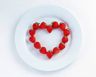 strawberries on round white ceramic plate