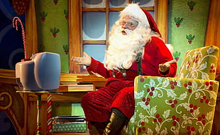 Santa Claus sitting on armchair in front of CRT TV