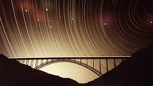 brown and black wooden table, bridge, star trails, long exposure, silhouette