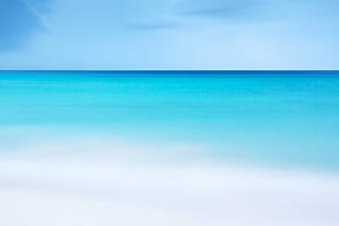 blue sea with white sand during daytime