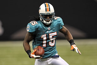 Miami Dolphins 15 NFL player holding the football while runnign HD wallpaper