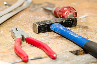 shallow photography on red plaise, blue hammer and red screw driver tools on ground HD wallpaper