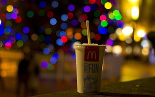 shallow focus photography of McDonald's plastic drinking cup with straw