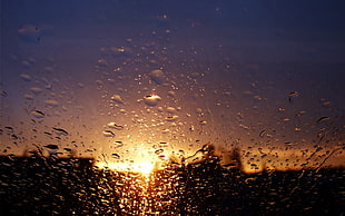 water drops on window during sunset