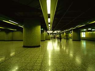 people walking inside building with lights on HD wallpaper