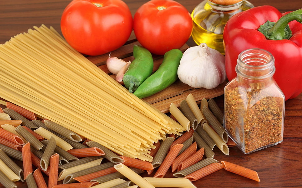 pasta beside tomatoes and seasoning on table HD wallpaper