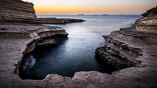 brown rock formation near body of water, malta HD wallpaper