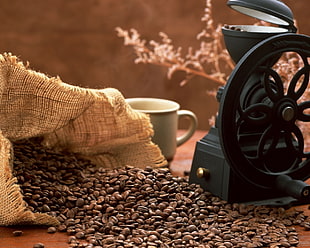 spilled coffee beans in sack beside black machine and white ceramic mug HD wallpaper