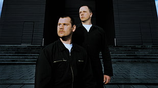 two men wearing black long sleeves top
